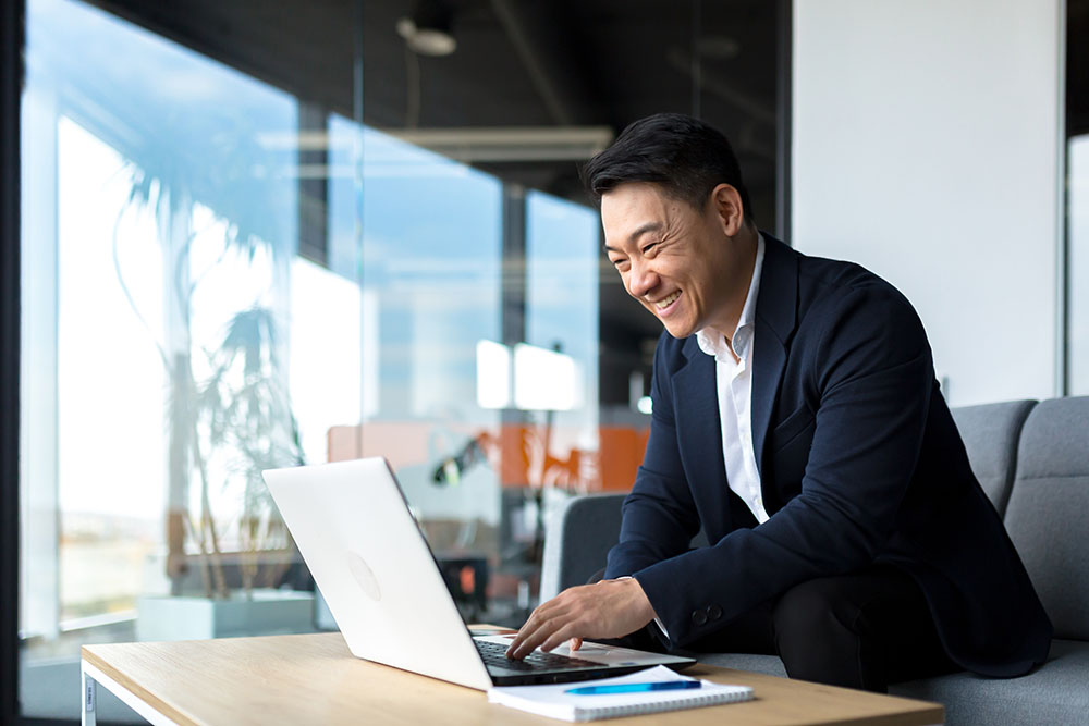 Senior Asian business man working on laptop